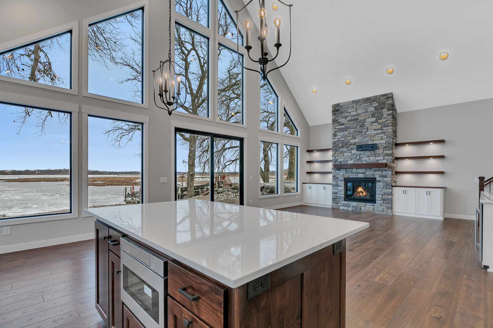 A kitchen with a large island and a fireplace.
