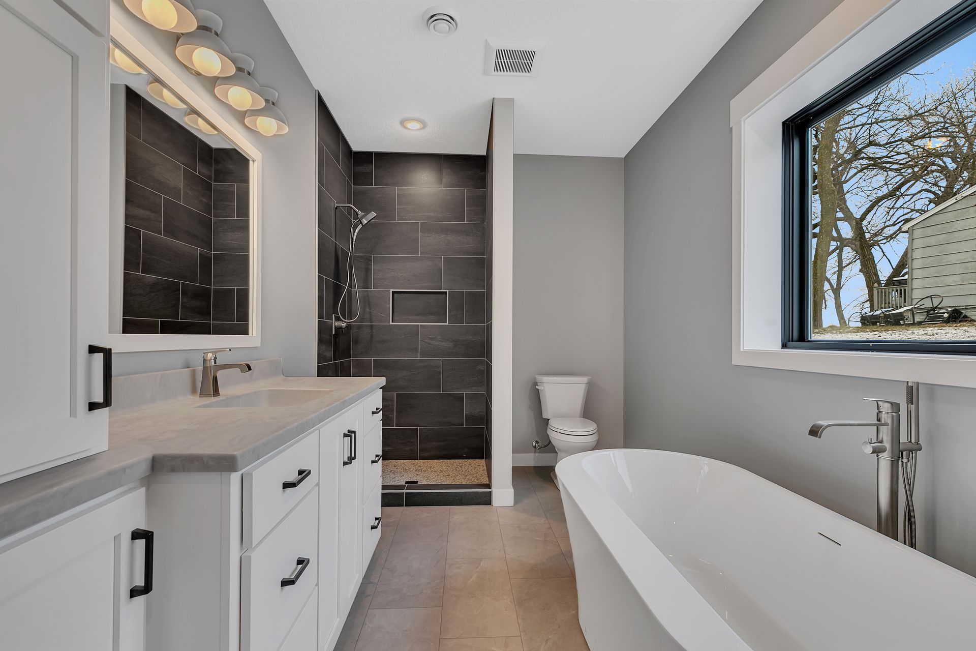 A bathroom with a tub , sink , toilet and shower.