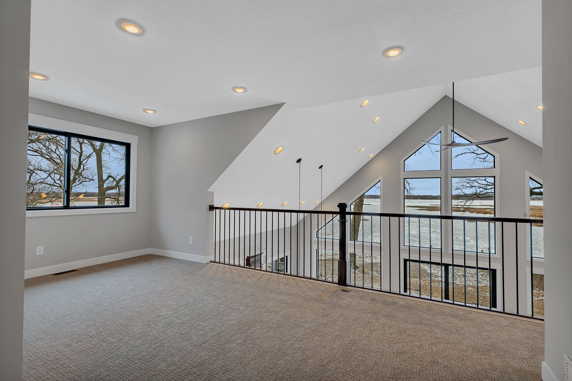 There is a balcony in the middle of the room with a railing.