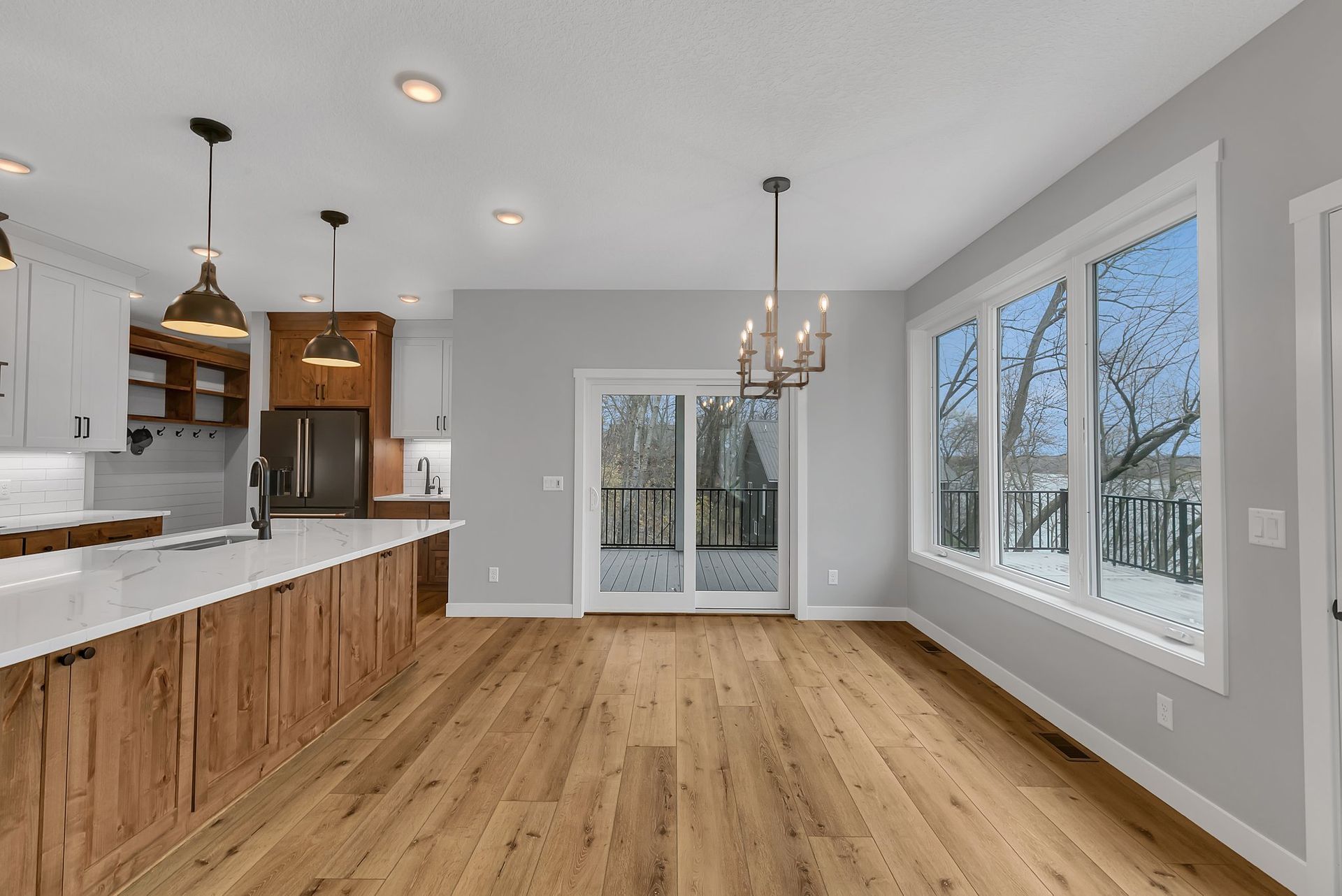 A kitchen with a lot of windows and wooden floors.