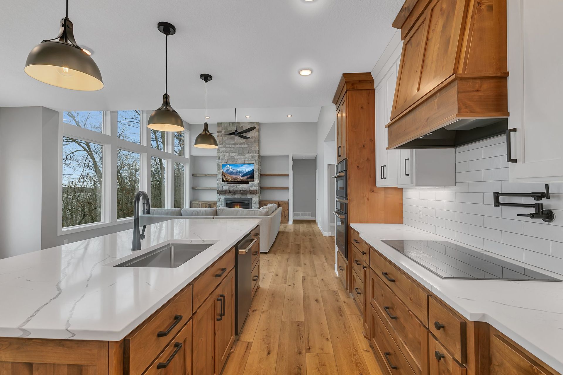 A kitchen with wooden cabinets and white counter tops.