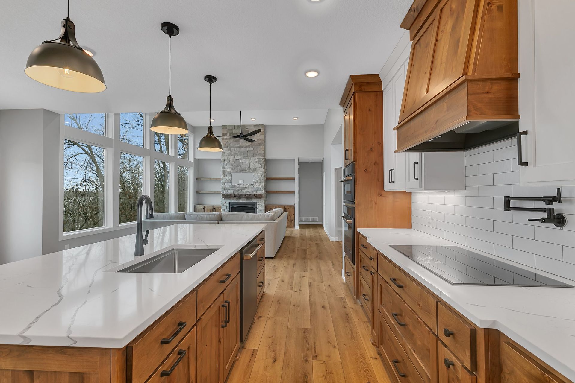 A kitchen with wooden cabinets and white counter tops.