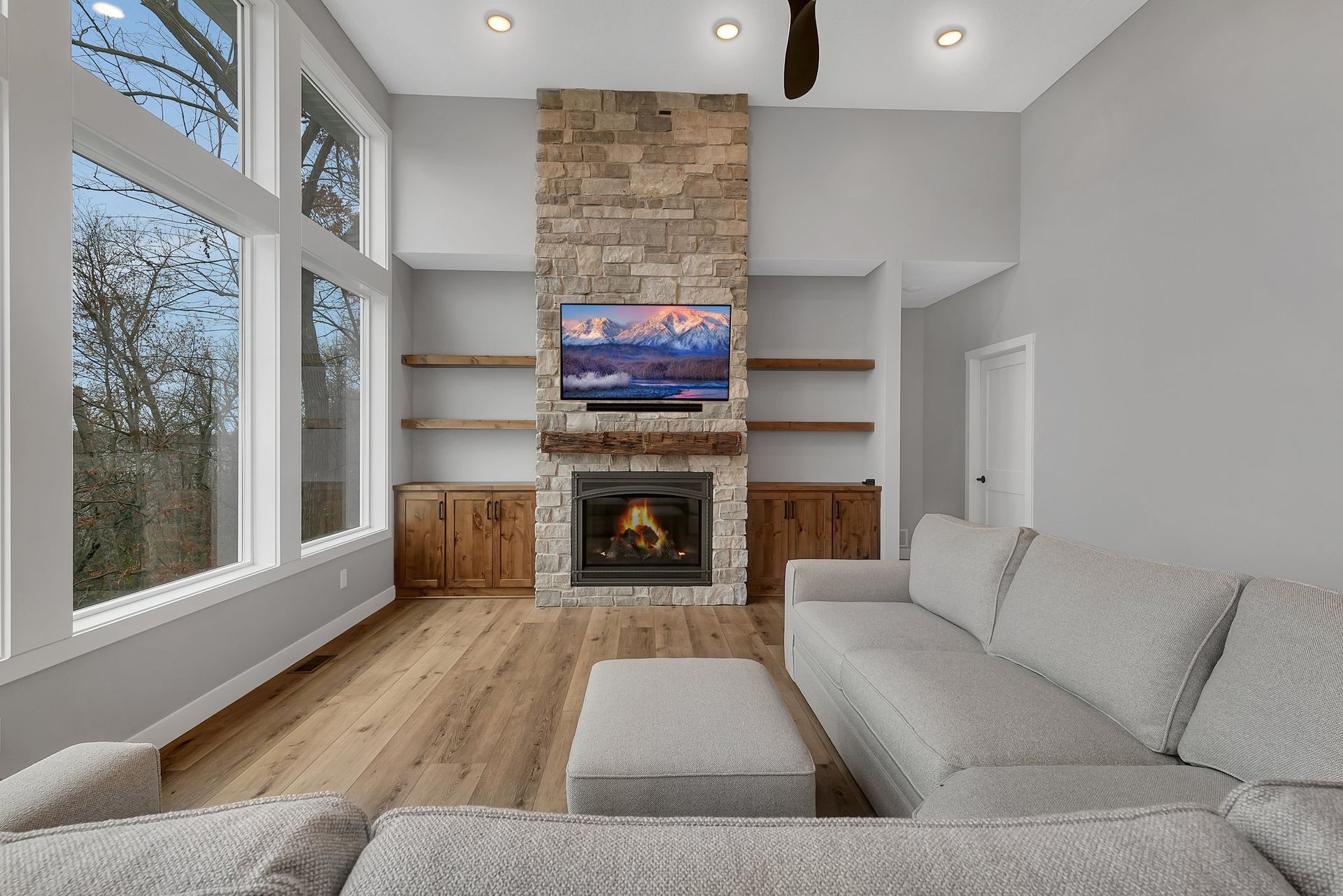 A living room with a couch , fireplace and television.
