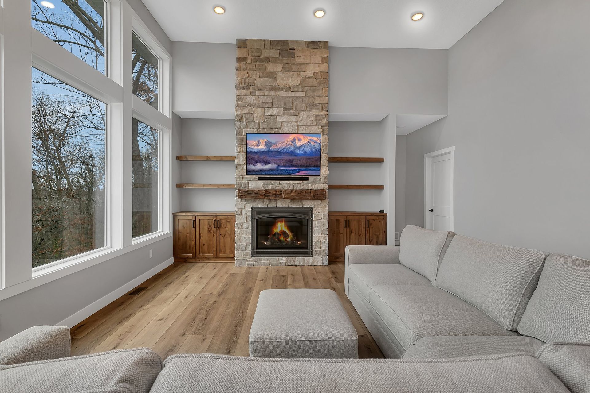 A living room with a couch , fireplace , and television.