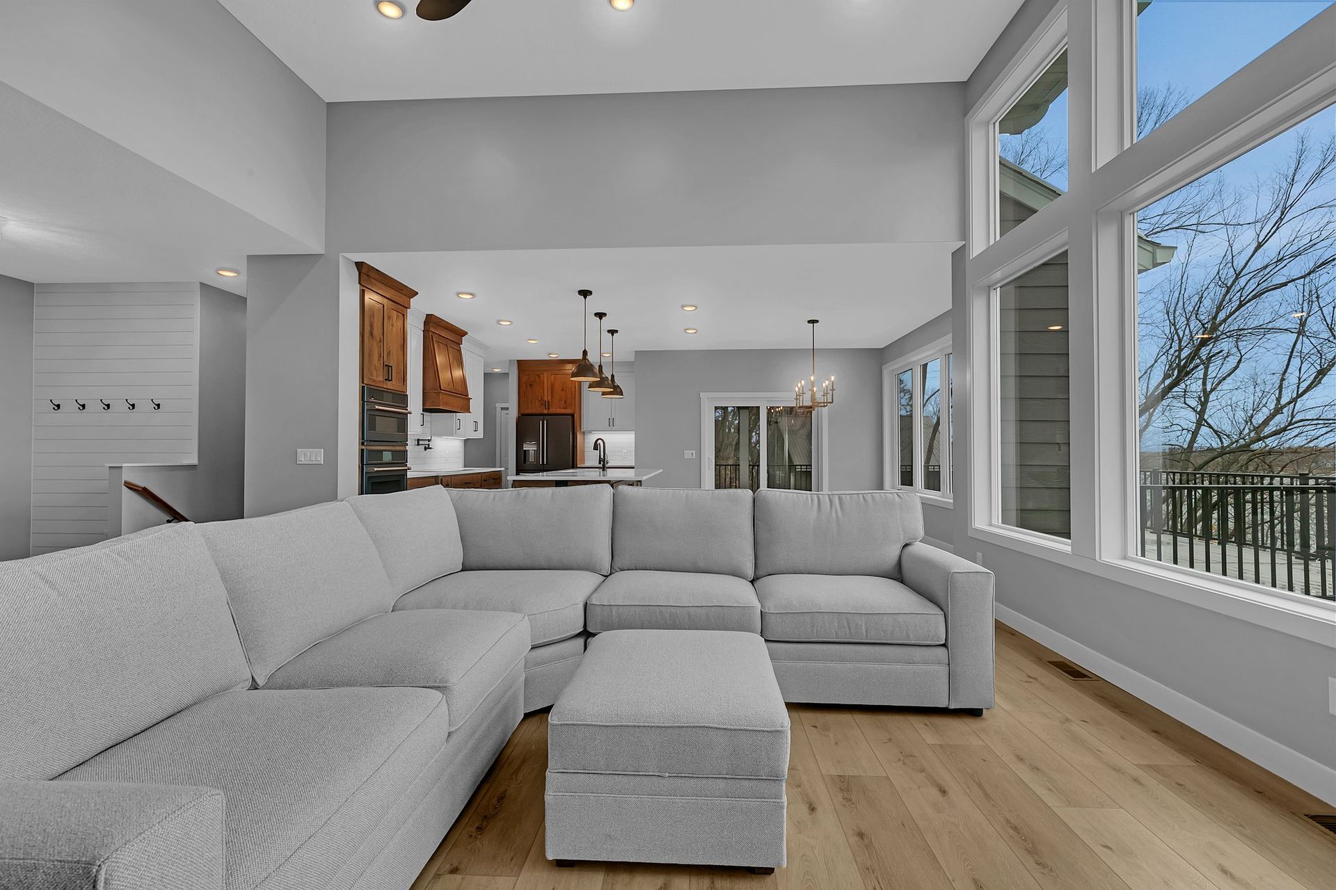 A living room with a large sectional couch and ottoman.