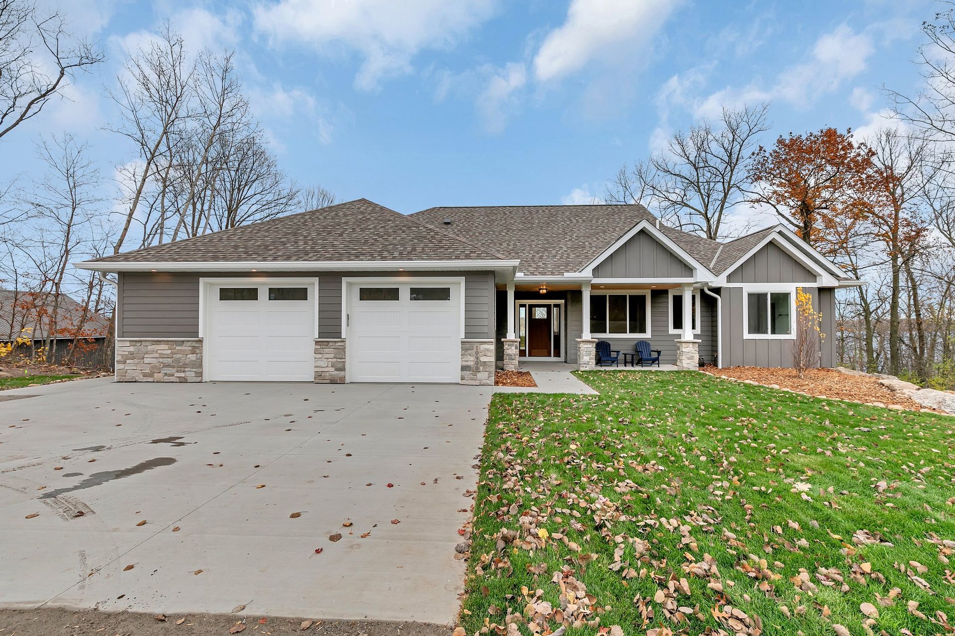 The front of a house with two garages and a large driveway.