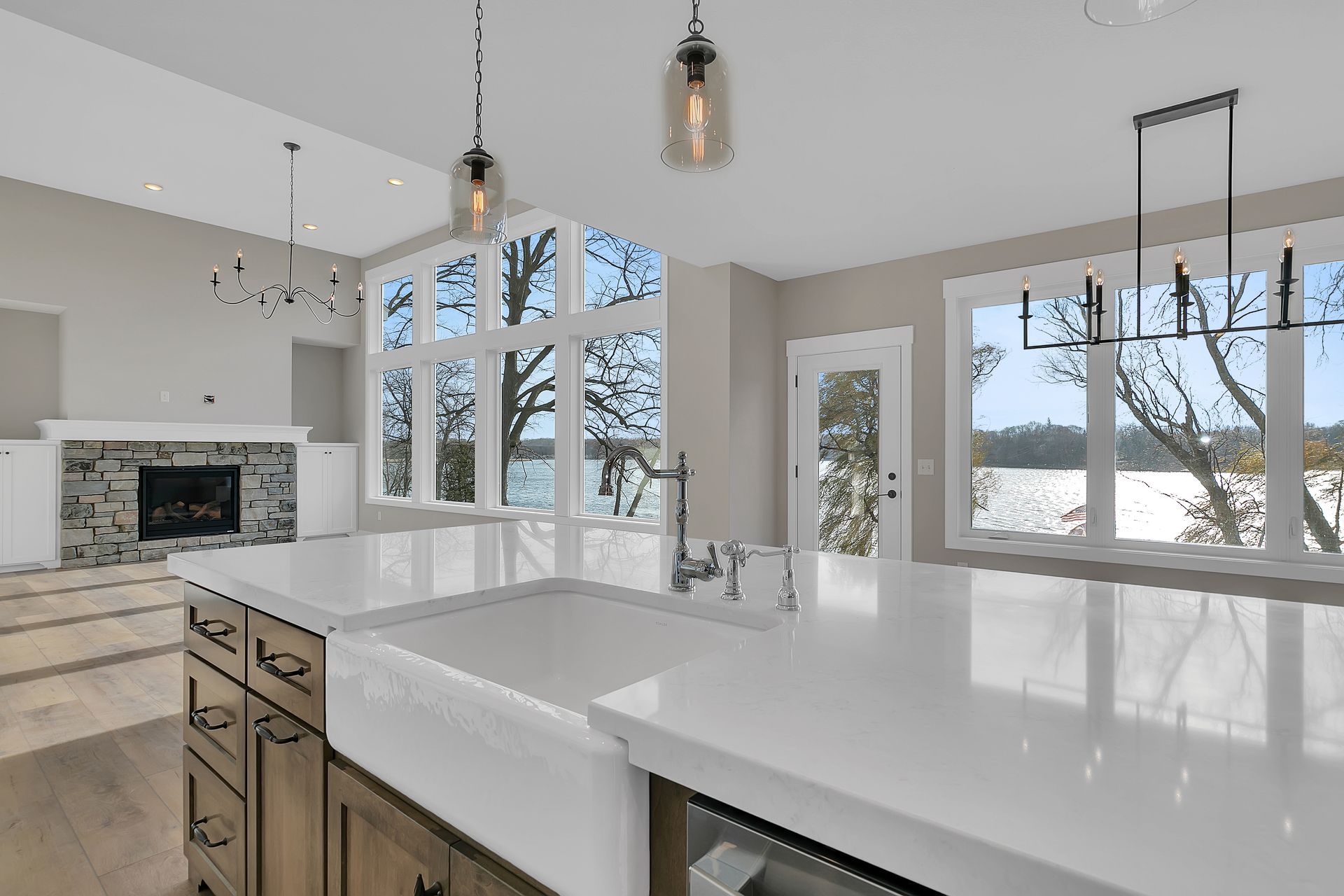 A kitchen with a large sink and a lot of windows.