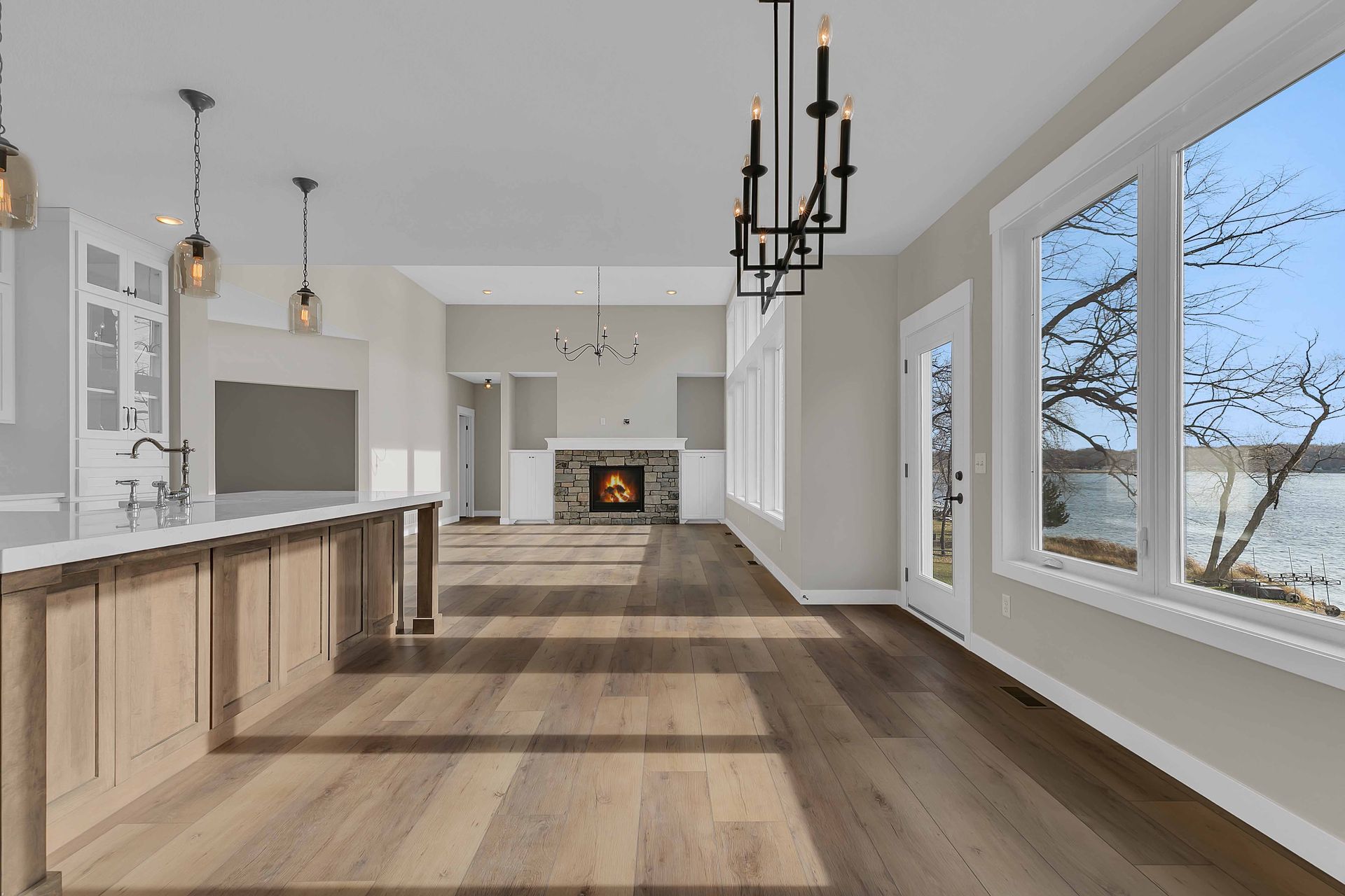 An empty living room with hardwood floors and a fireplace.