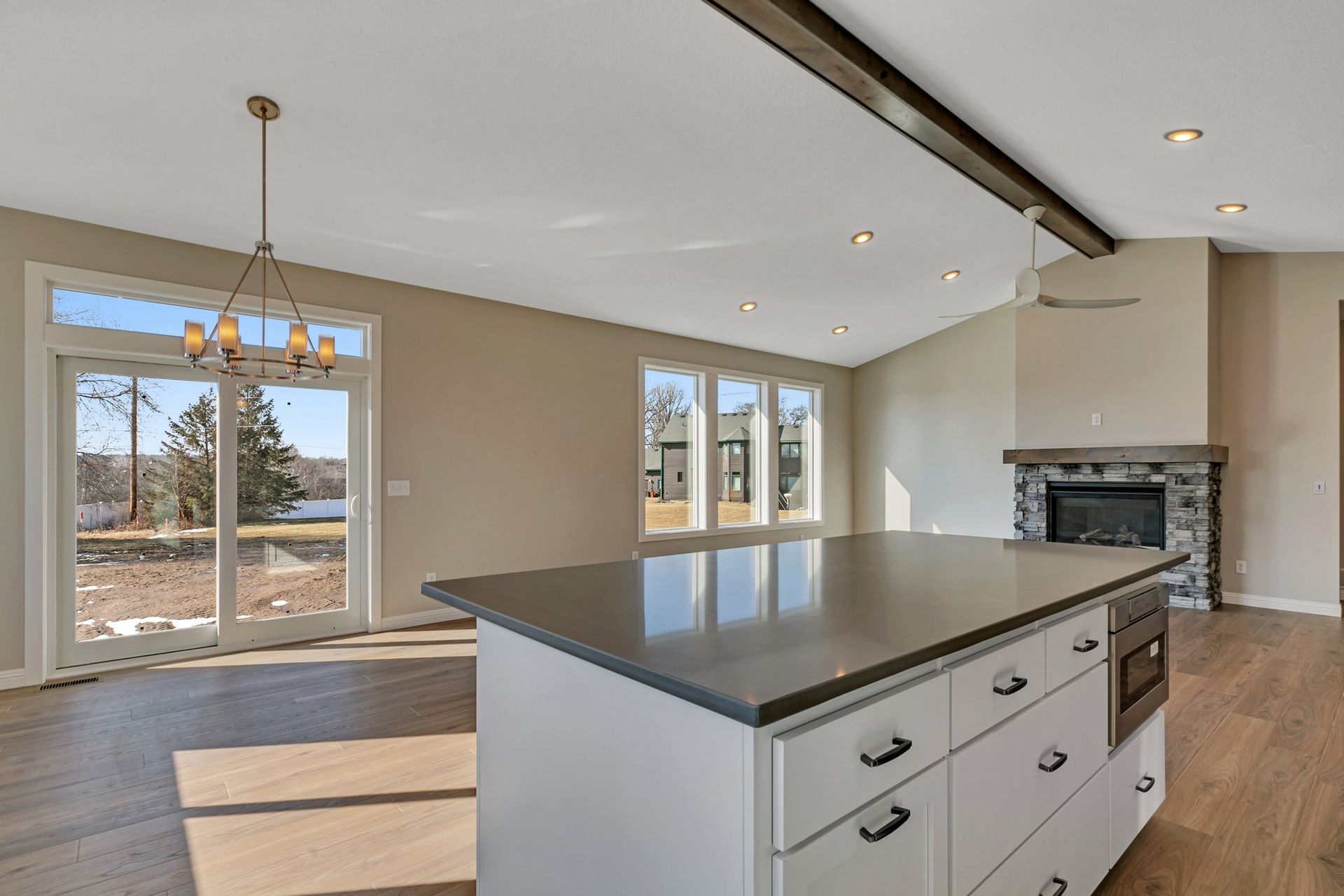 A kitchen with a large island and a fireplace.