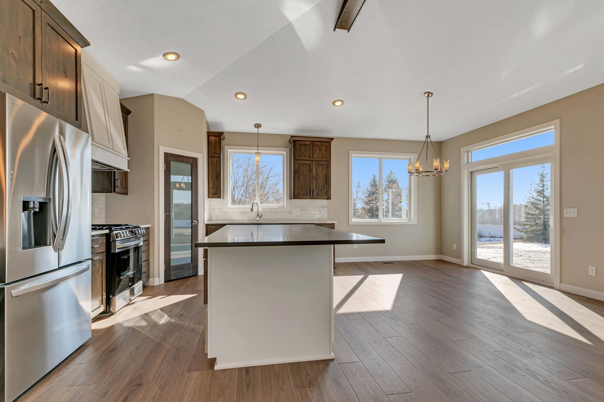 A kitchen with stainless steel appliances and a large island.