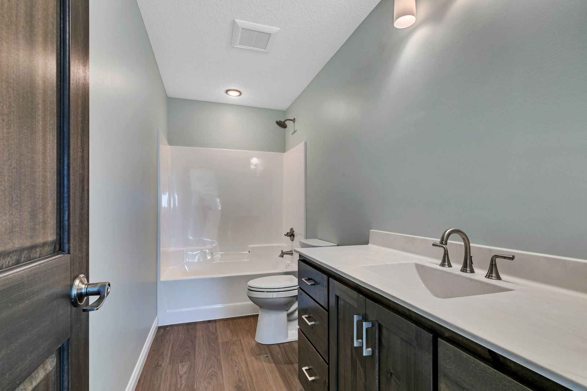 A bathroom with a sink , toilet and bathtub.