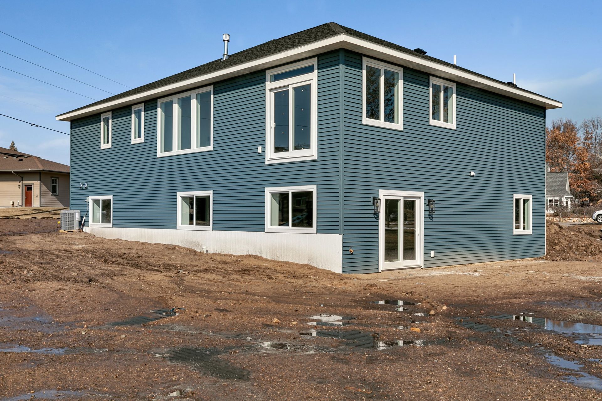 A blue house with a lot of windows and doors
