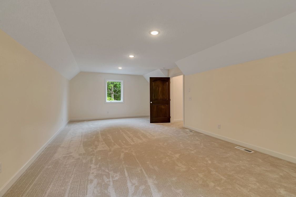 An empty room with a window and a door.