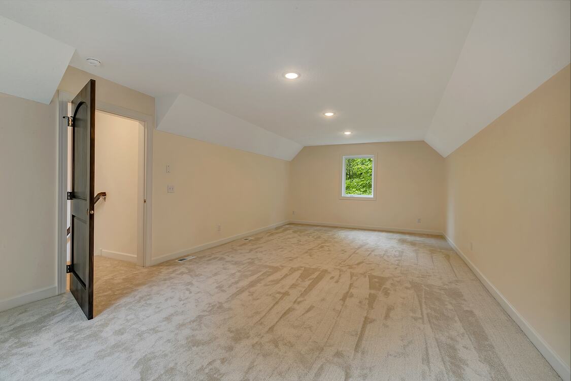 An empty room with a window and a door.