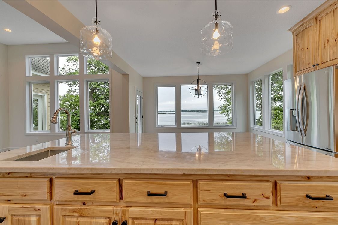 A kitchen with a large island and a sink.