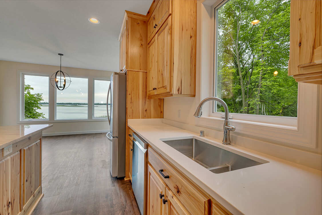 A kitchen with wooden cabinets and a stainless steel sink.