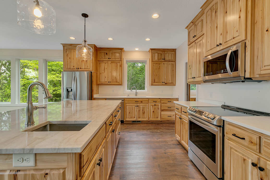 A kitchen with wooden cabinets and stainless steel appliances.