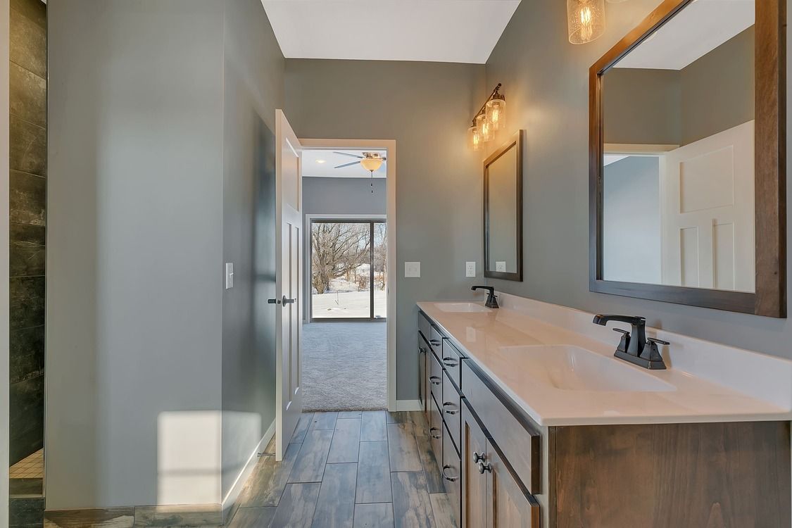 A bathroom with two sinks and two mirrors.