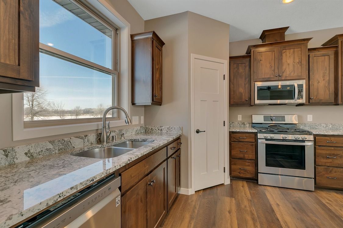 A kitchen with stainless steel appliances and granite counter tops.