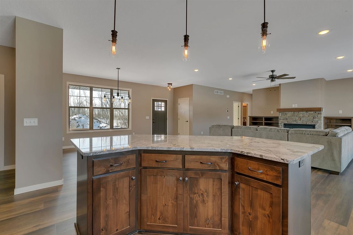 A kitchen with wooden cabinets and granite counter tops.