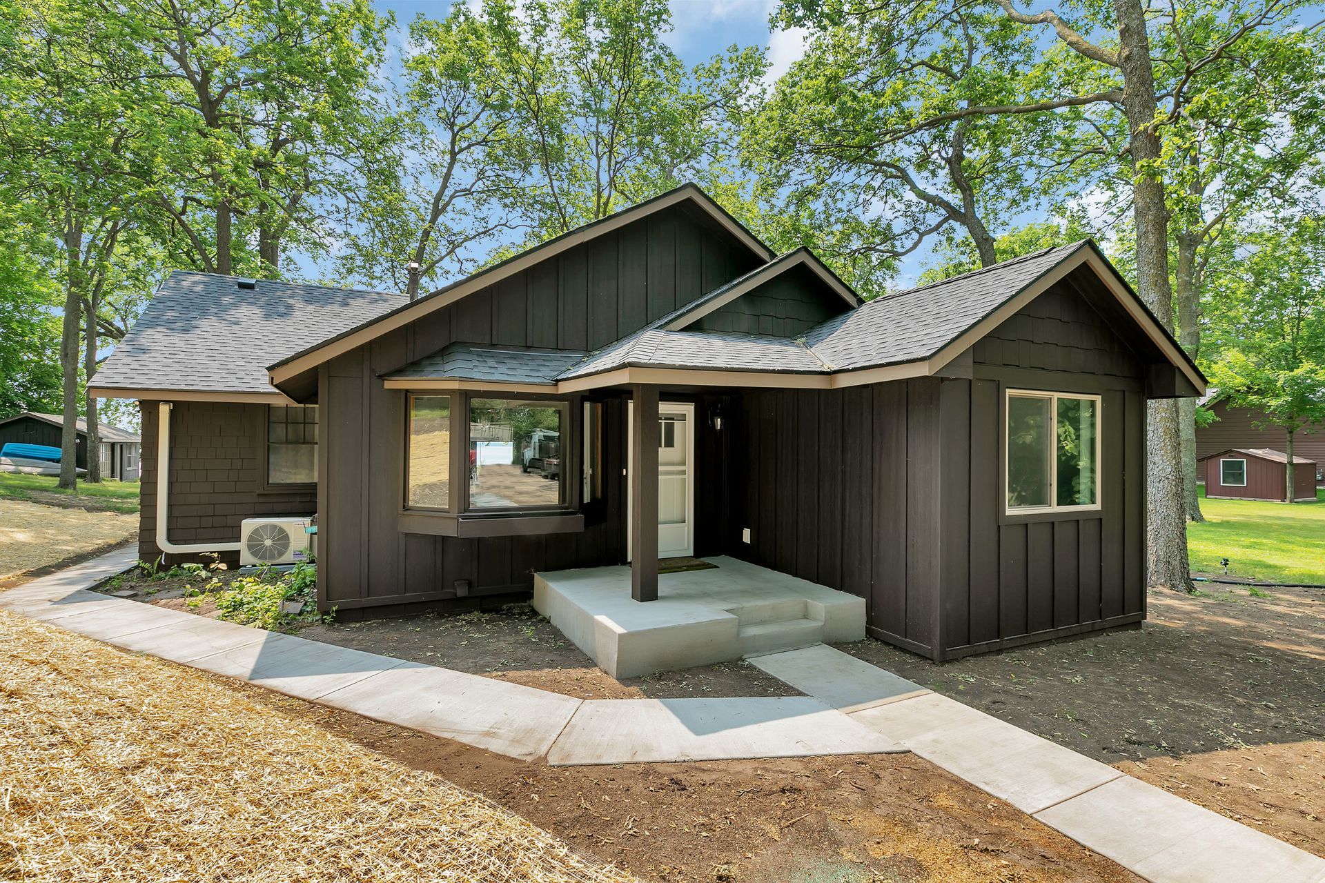 A small brown house with a walkway leading to it