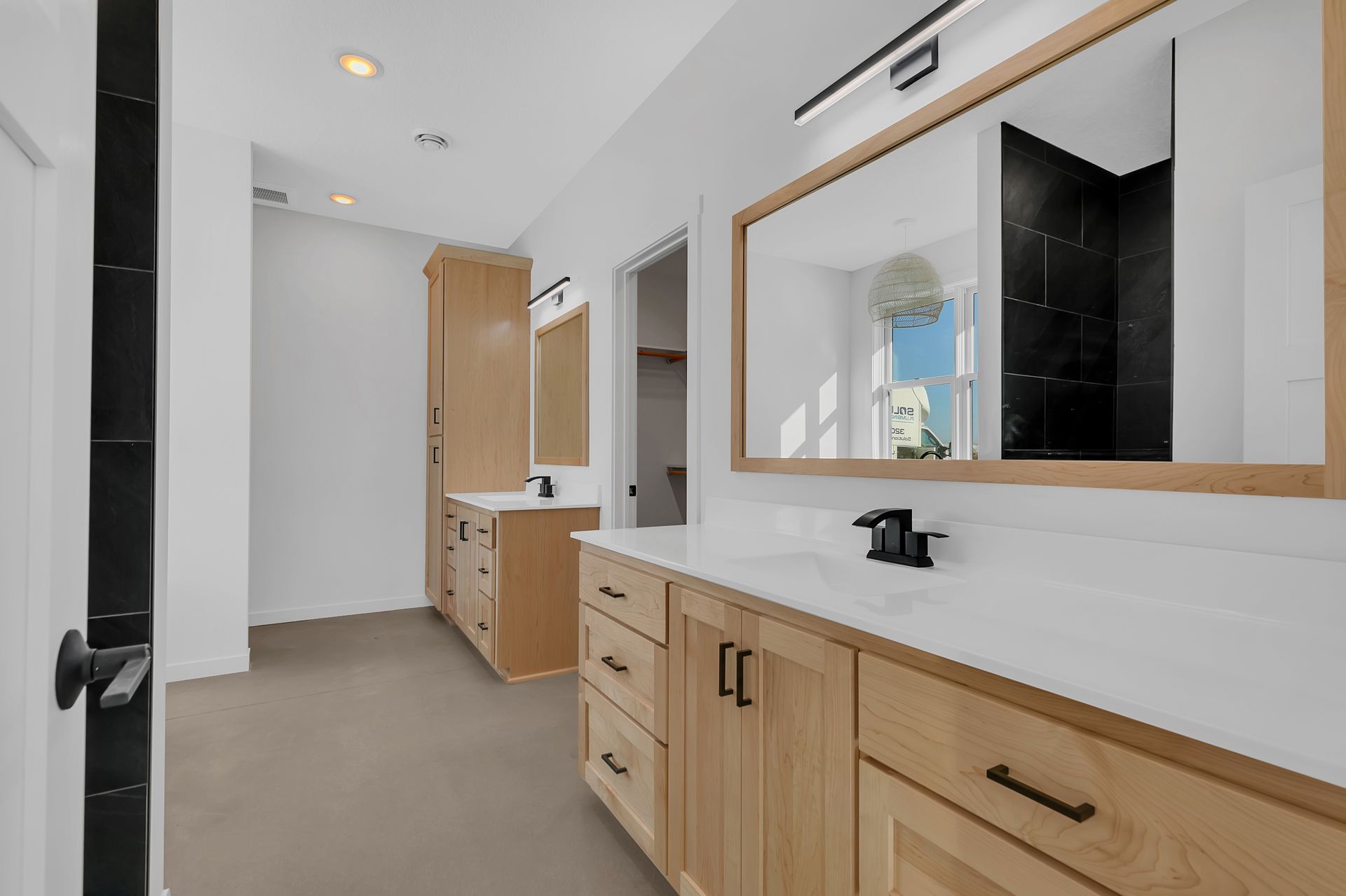 A bathroom with two sinks and a large mirror.