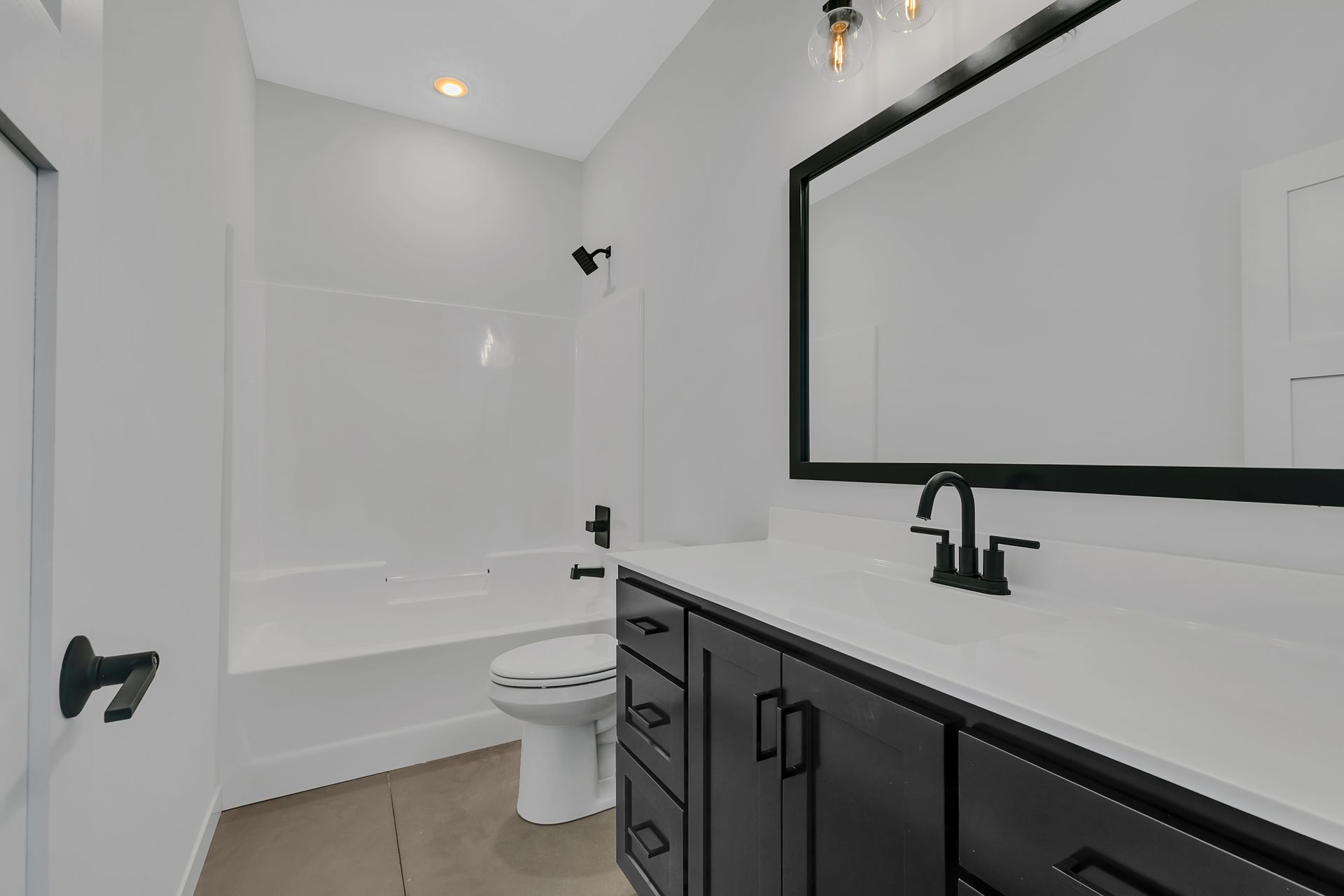 A bathroom with a toilet , sink , mirror and bathtub.