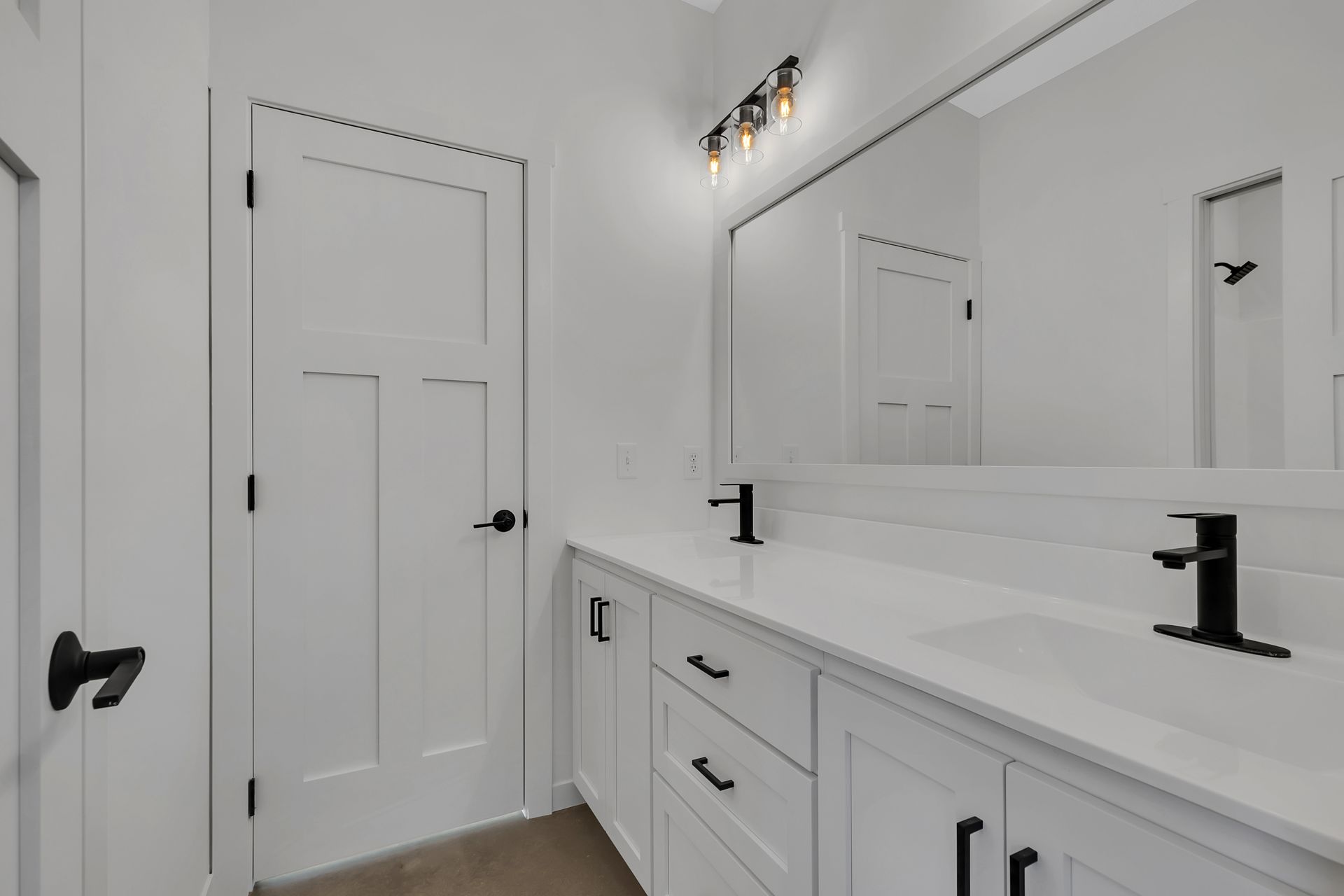 A bathroom with two sinks and a mirror.