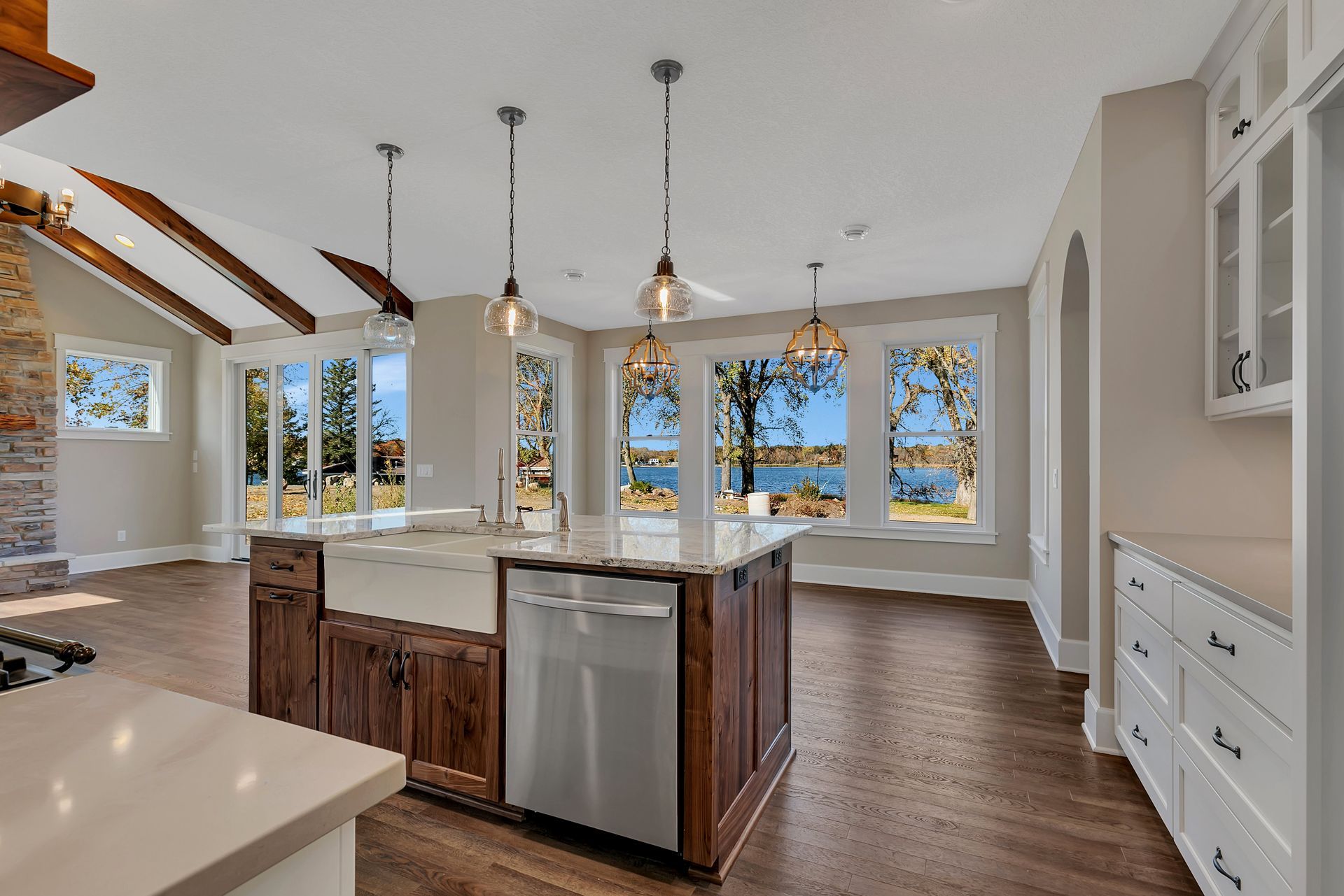 A kitchen with stainless steel appliances , wooden cabinets , and a large island.