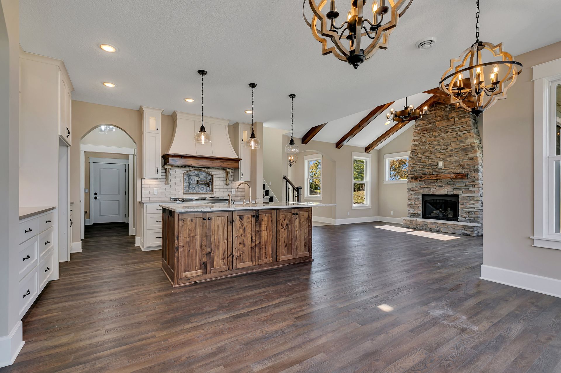 A kitchen with a wooden island and a fireplace