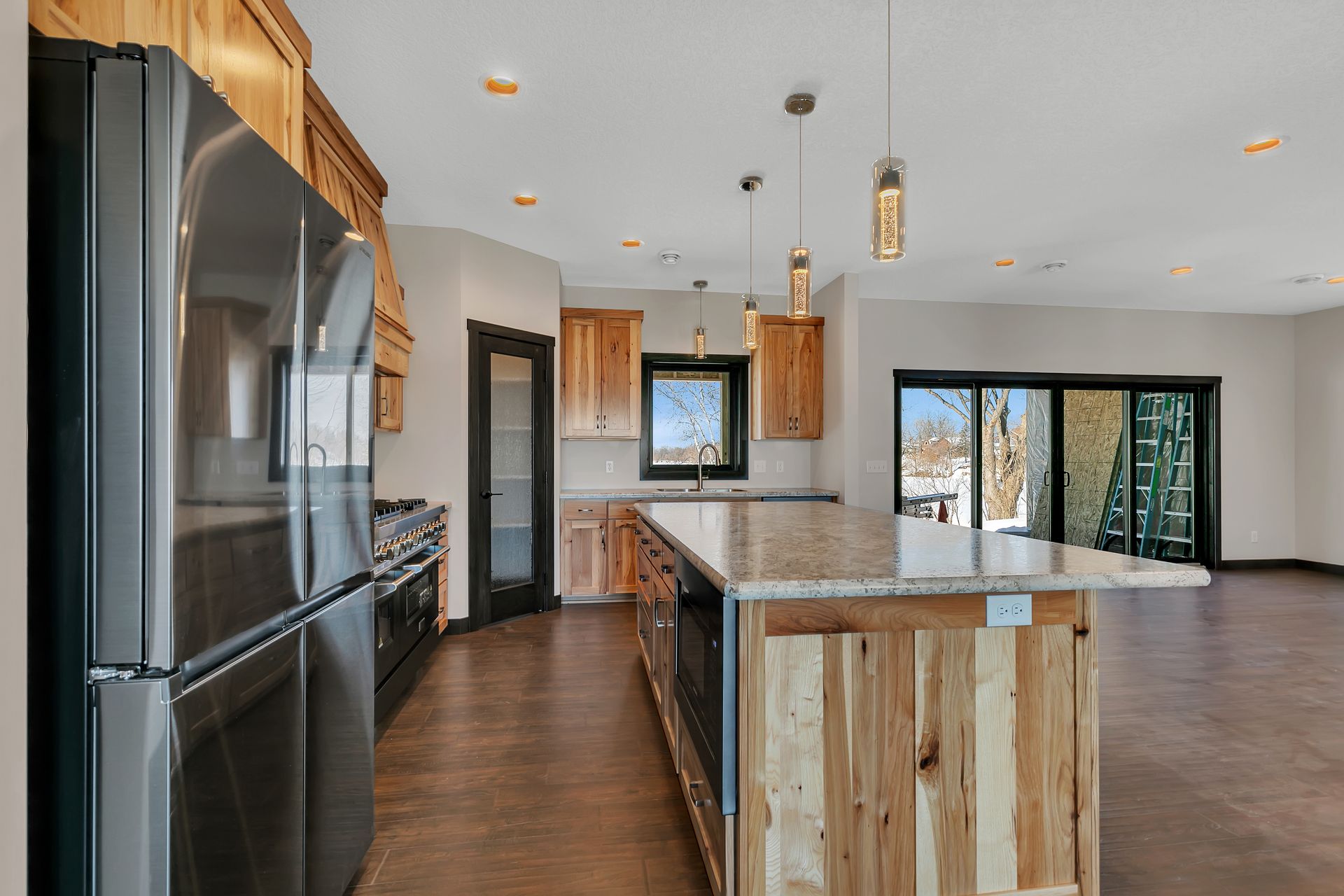A kitchen with a large island and stainless steel appliances.