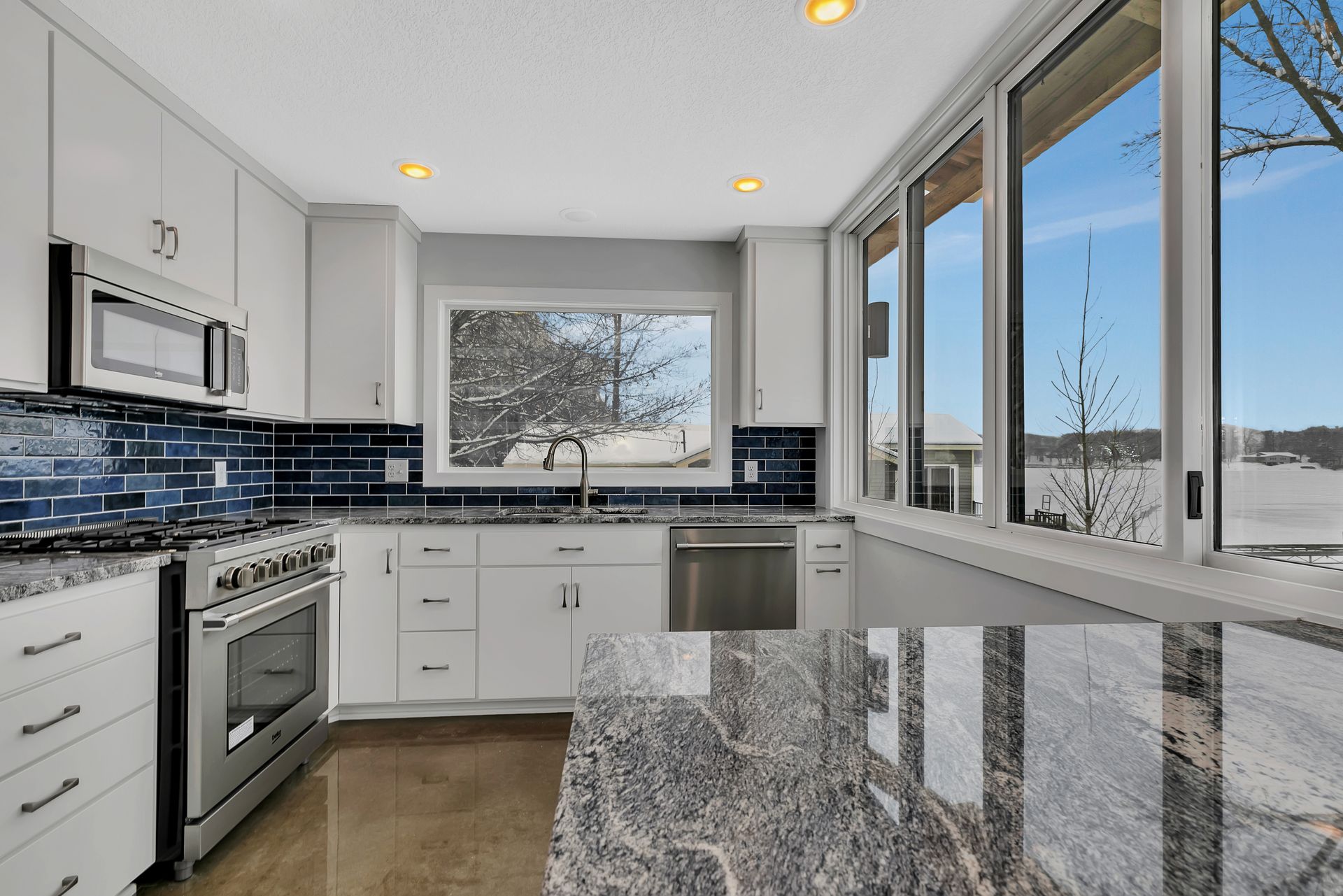 A kitchen with granite counter tops and stainless steel appliances