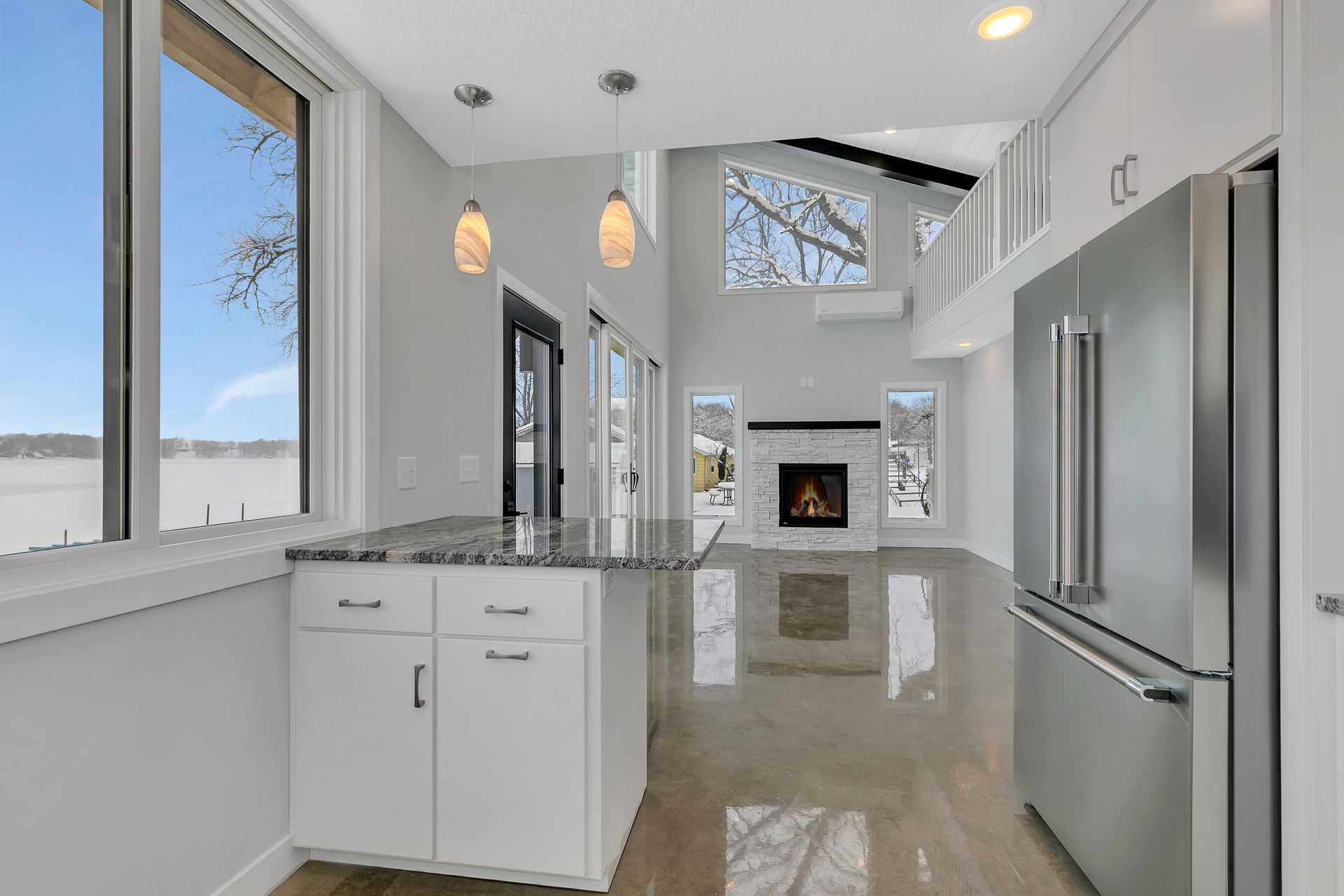 A kitchen with stainless steel appliances and a fireplace.