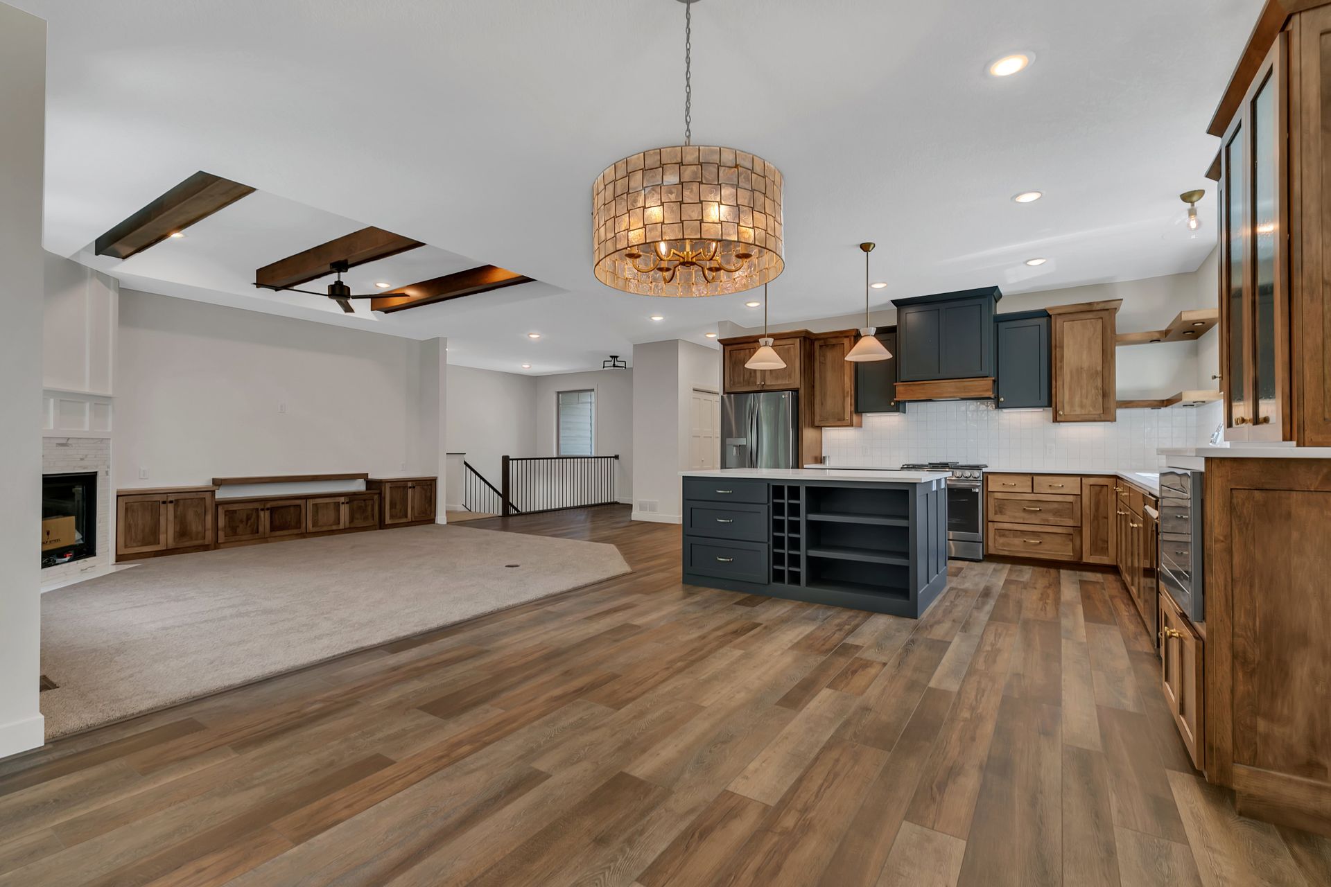 A kitchen with hardwood floors and a chandelier hanging from the ceiling.