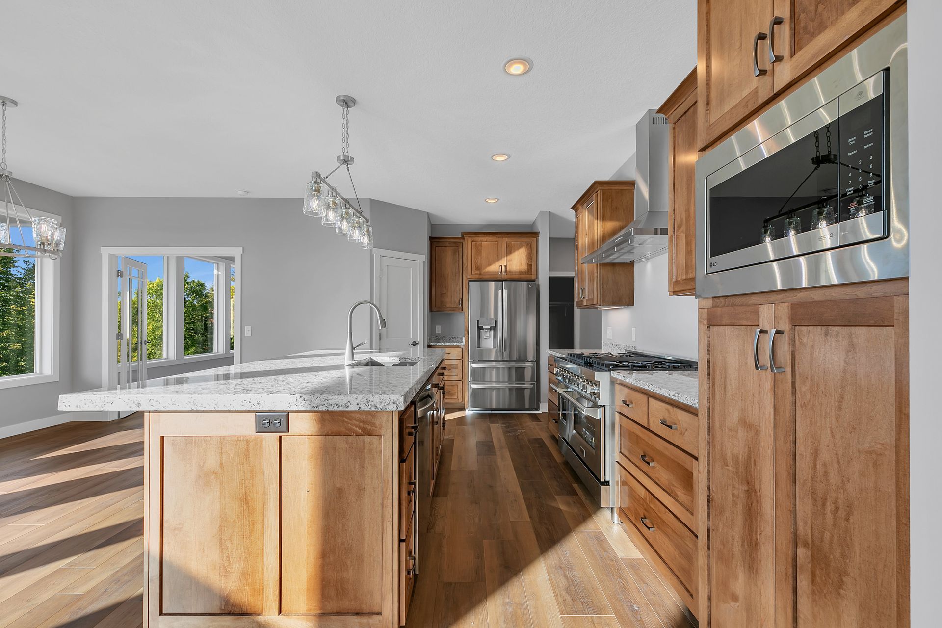 A kitchen with stainless steel appliances and wooden cabinets.