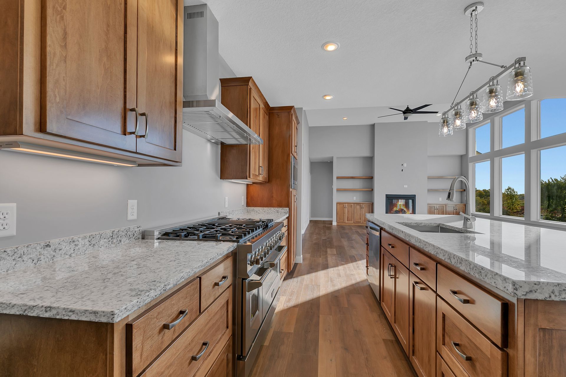 A kitchen with stainless steel appliances and granite counter tops.