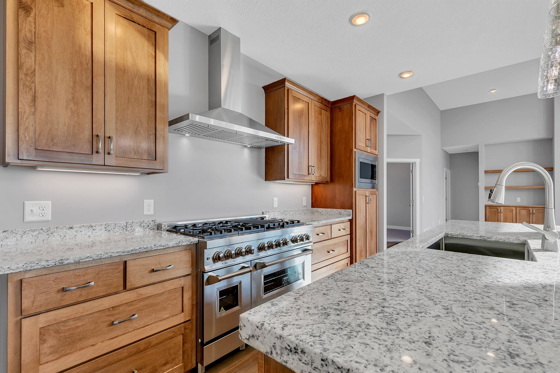 A kitchen with stainless steel appliances and granite counter tops.