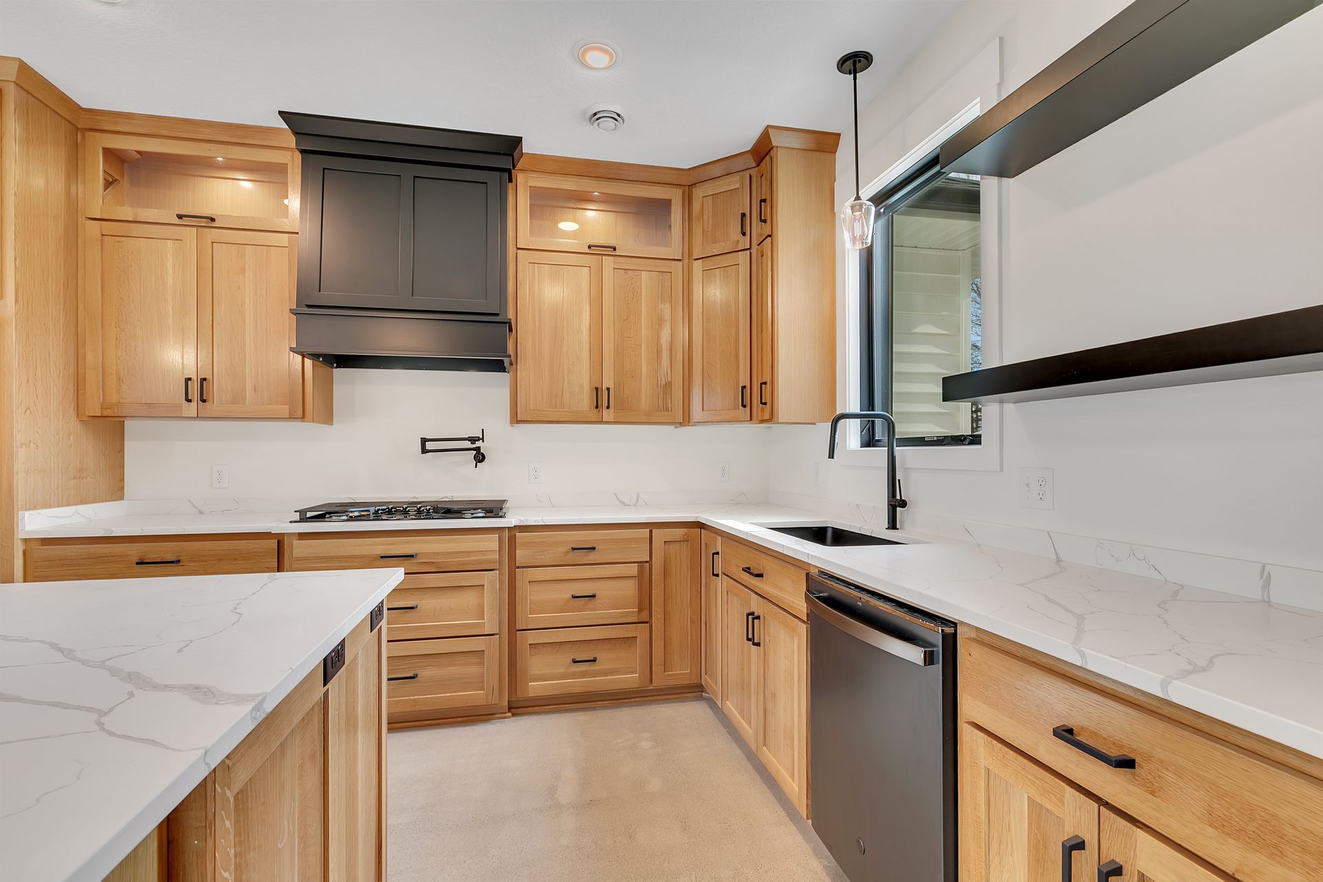 A kitchen with wooden cabinets and white counter tops.