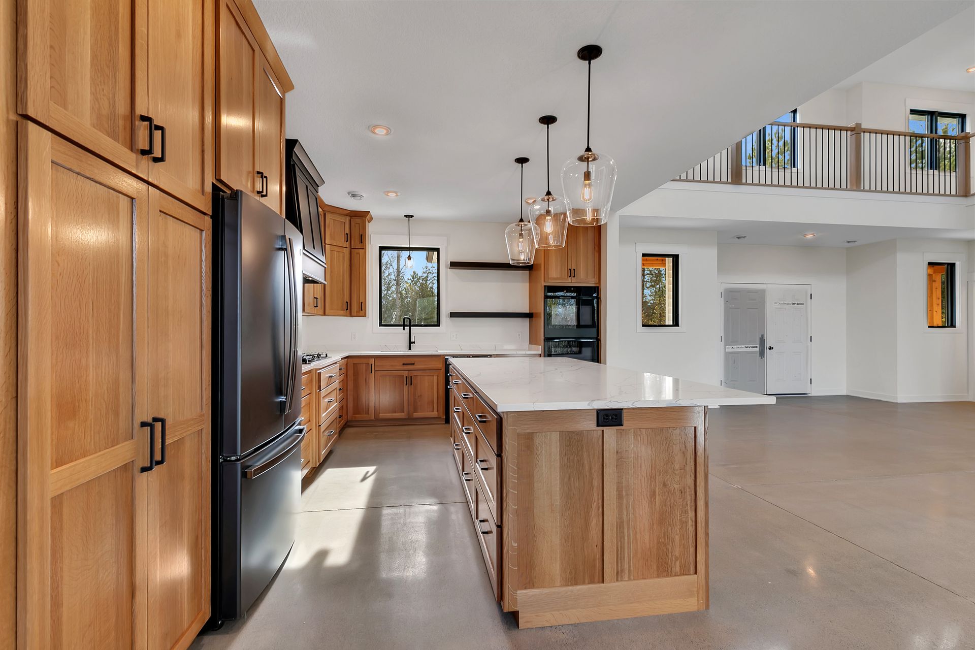 A kitchen with wooden cabinets and a large island.