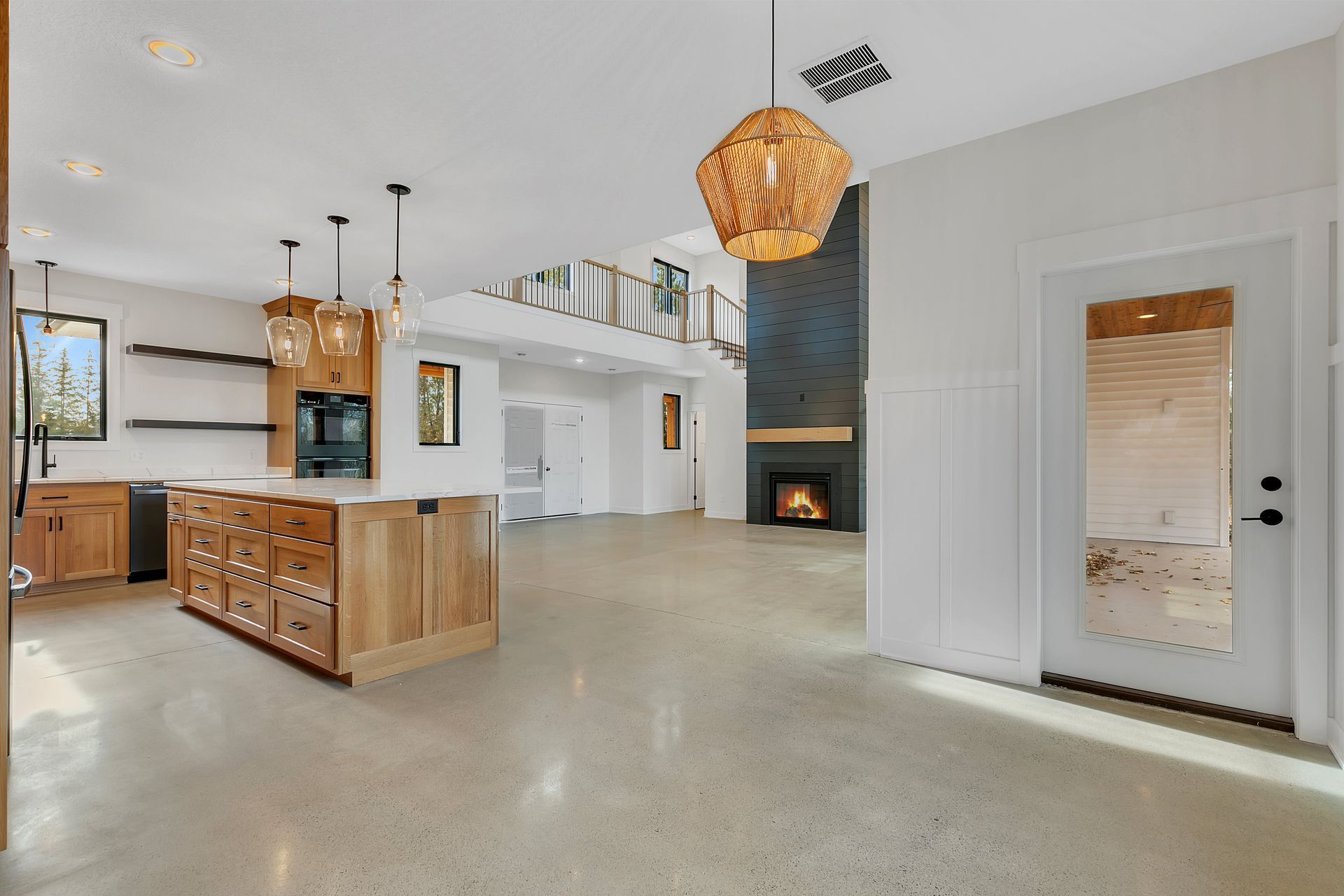 A kitchen with a large island in the middle of it and a fireplace.