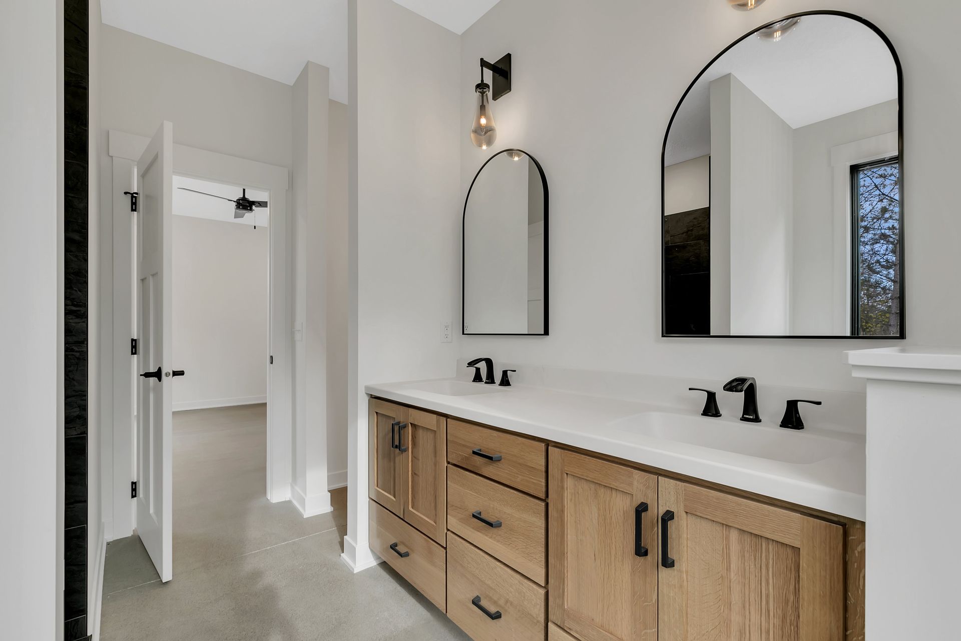 A bathroom with two sinks and two mirrors.