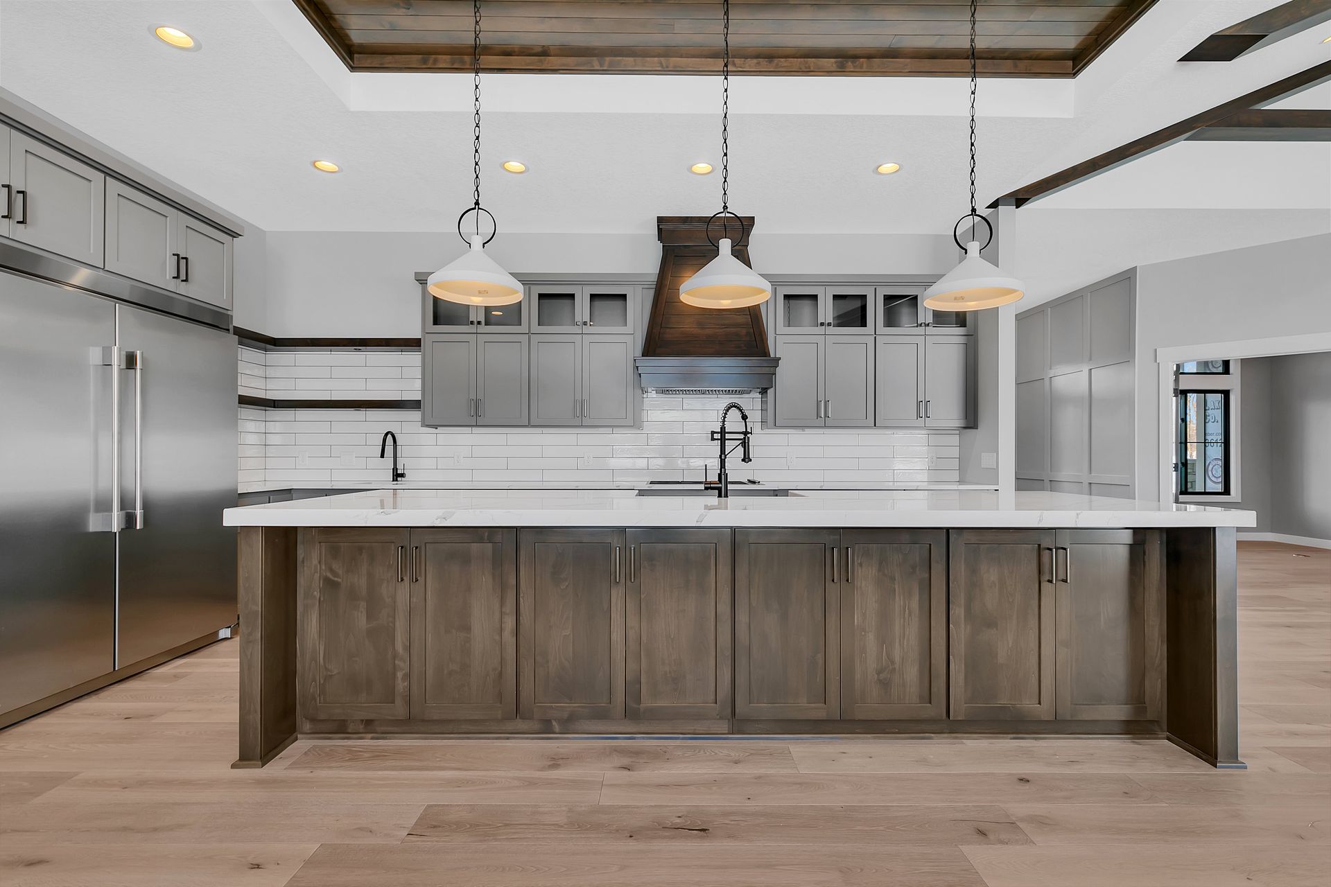 A kitchen with stainless steel appliances and wooden cabinets
