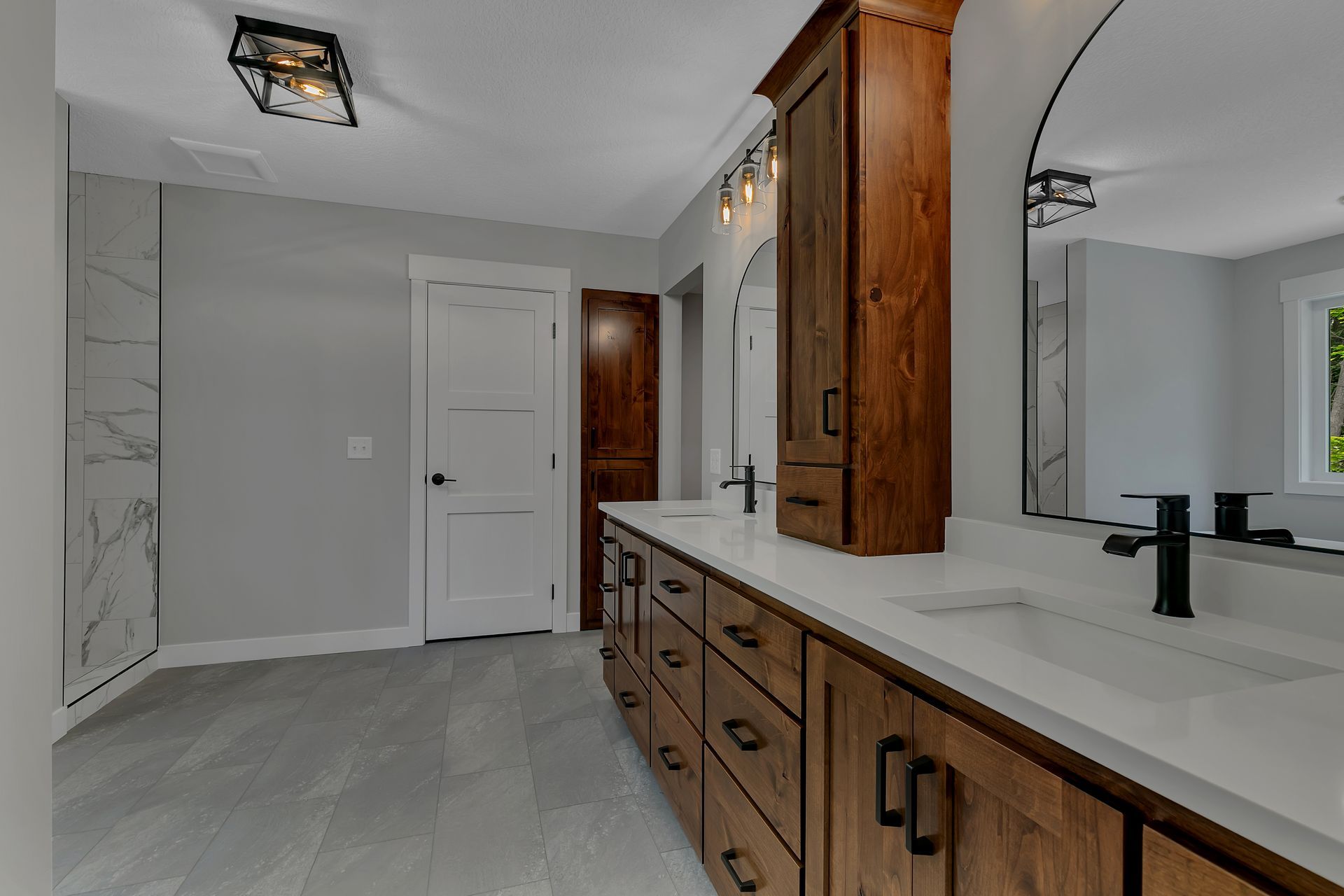 A bathroom with two sinks and a large mirror.