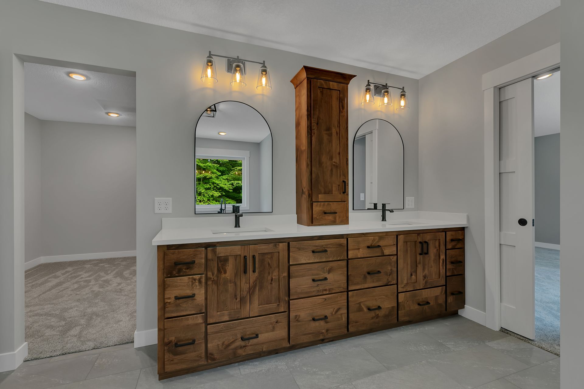 A bathroom with two sinks and two mirrors.