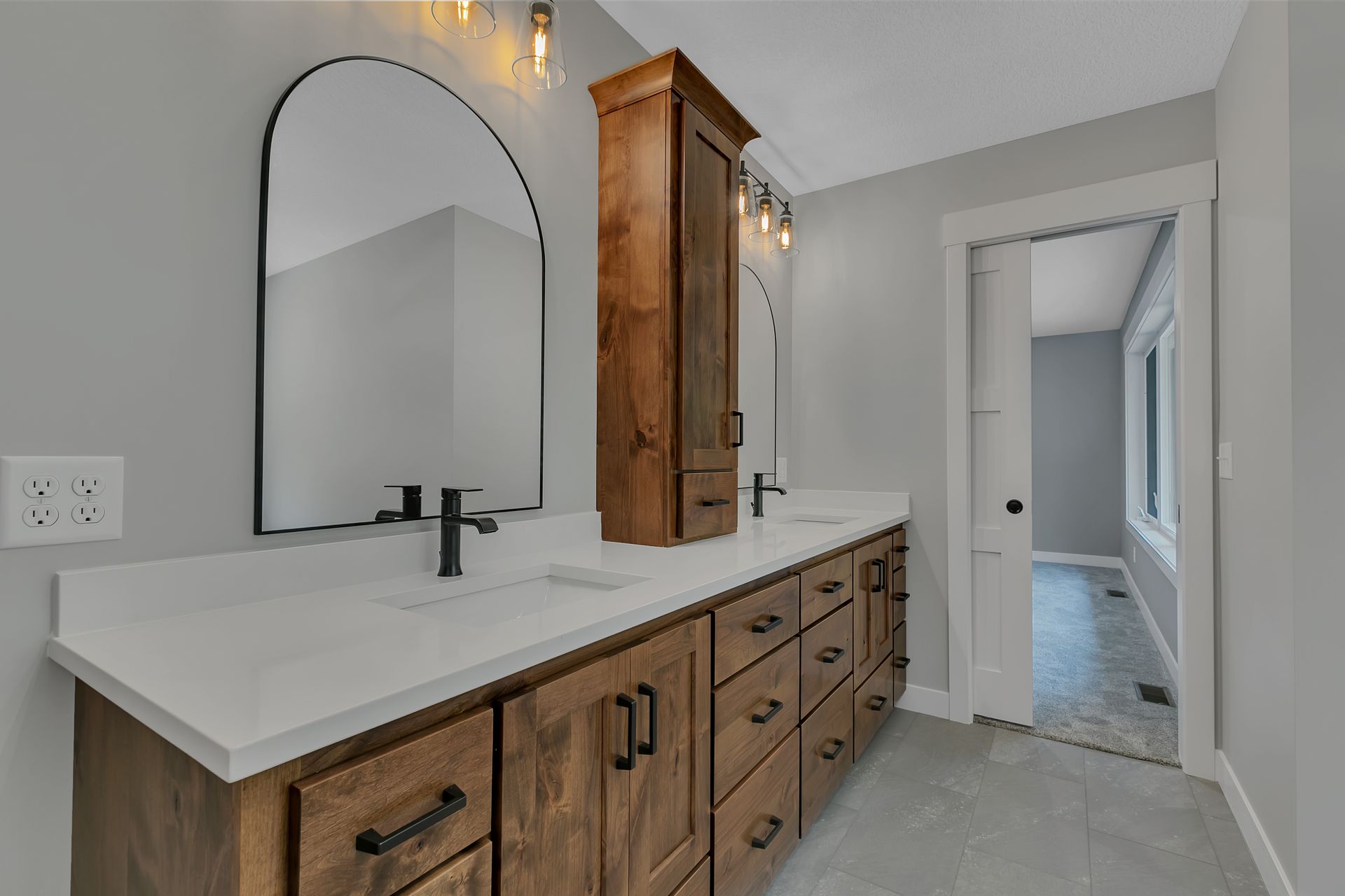 A bathroom with two sinks and a large mirror.