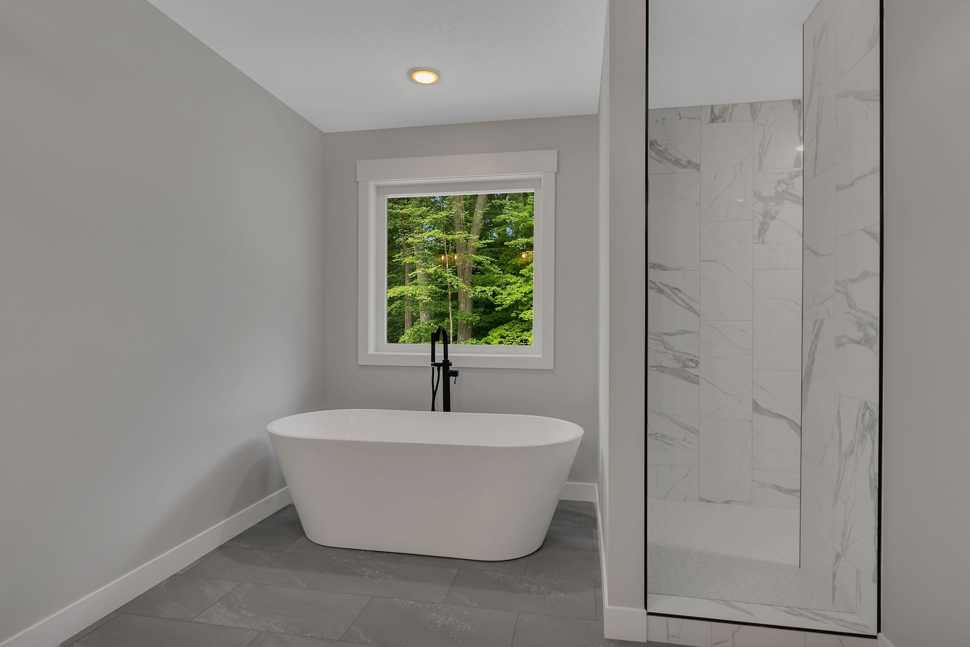 A bathroom with a bathtub and a walk in shower.