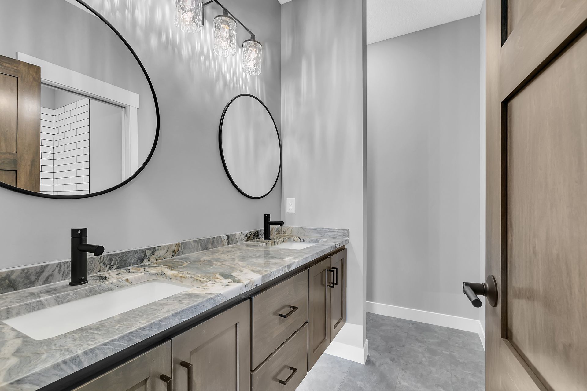 A bathroom with two sinks and two mirrors.