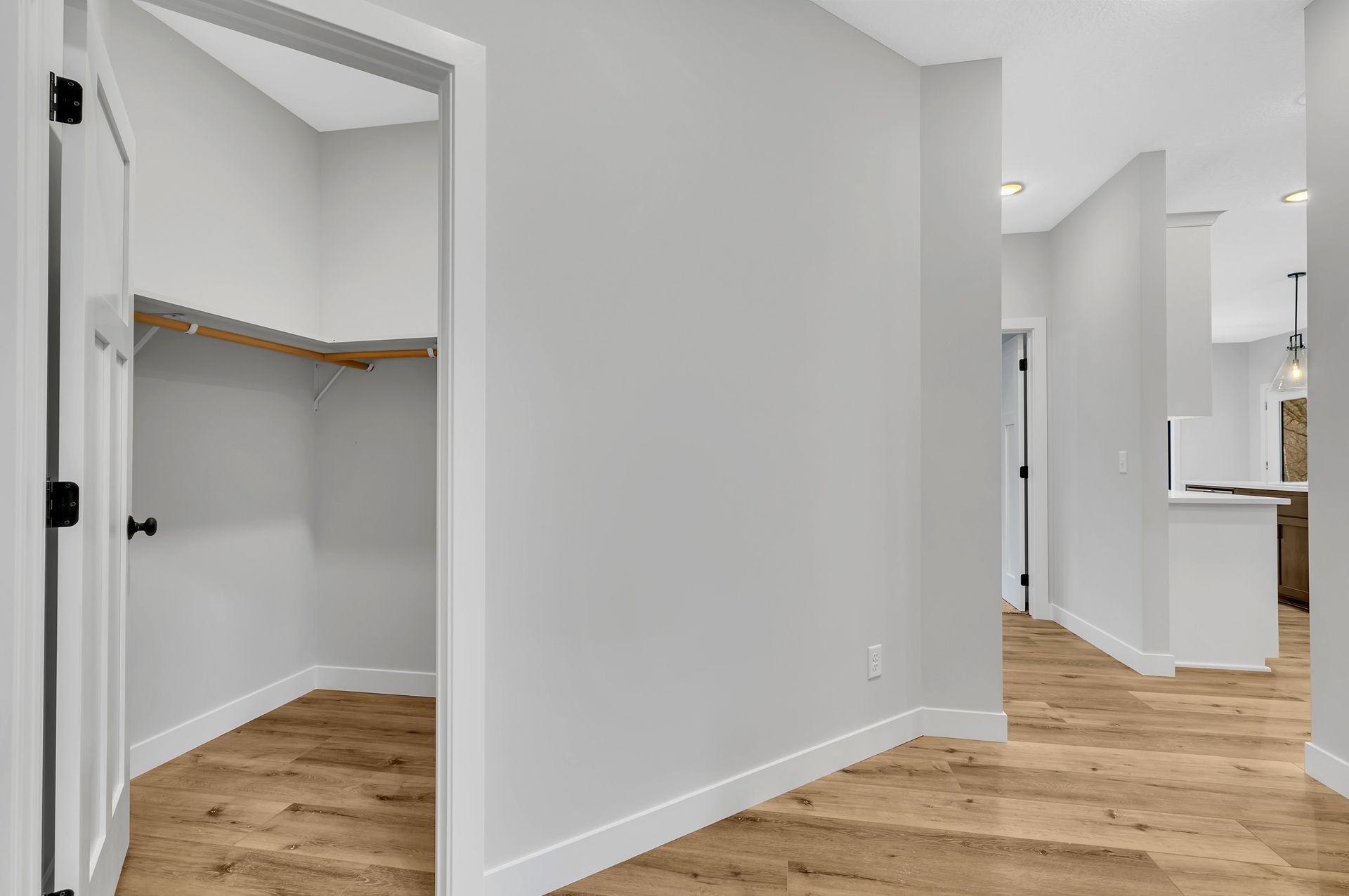 There is a walk in closet in the middle of the hallway.