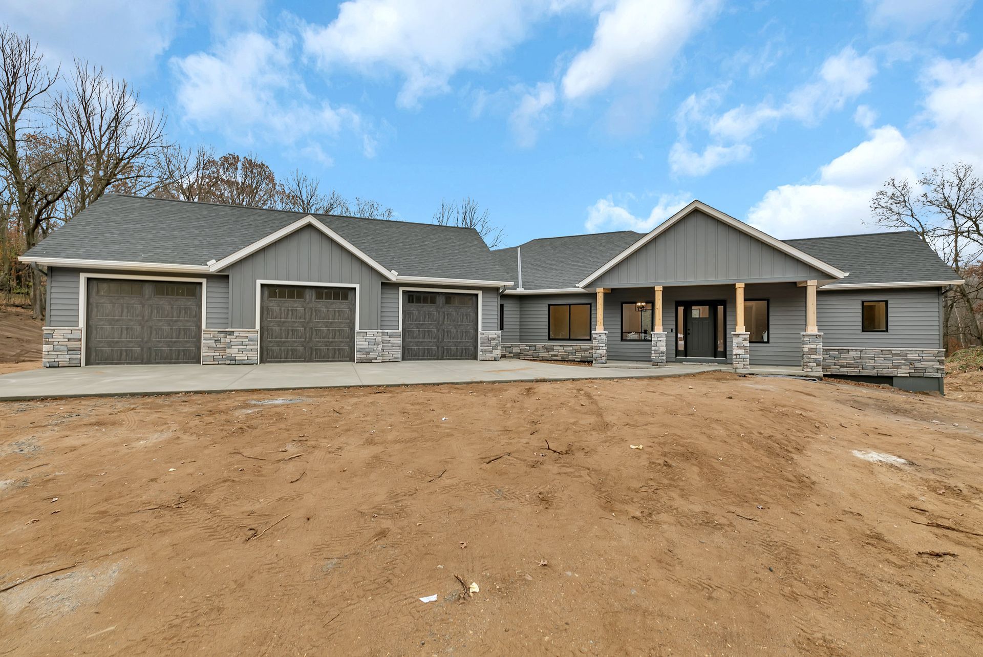 A large house with a lot of garages and a porch
