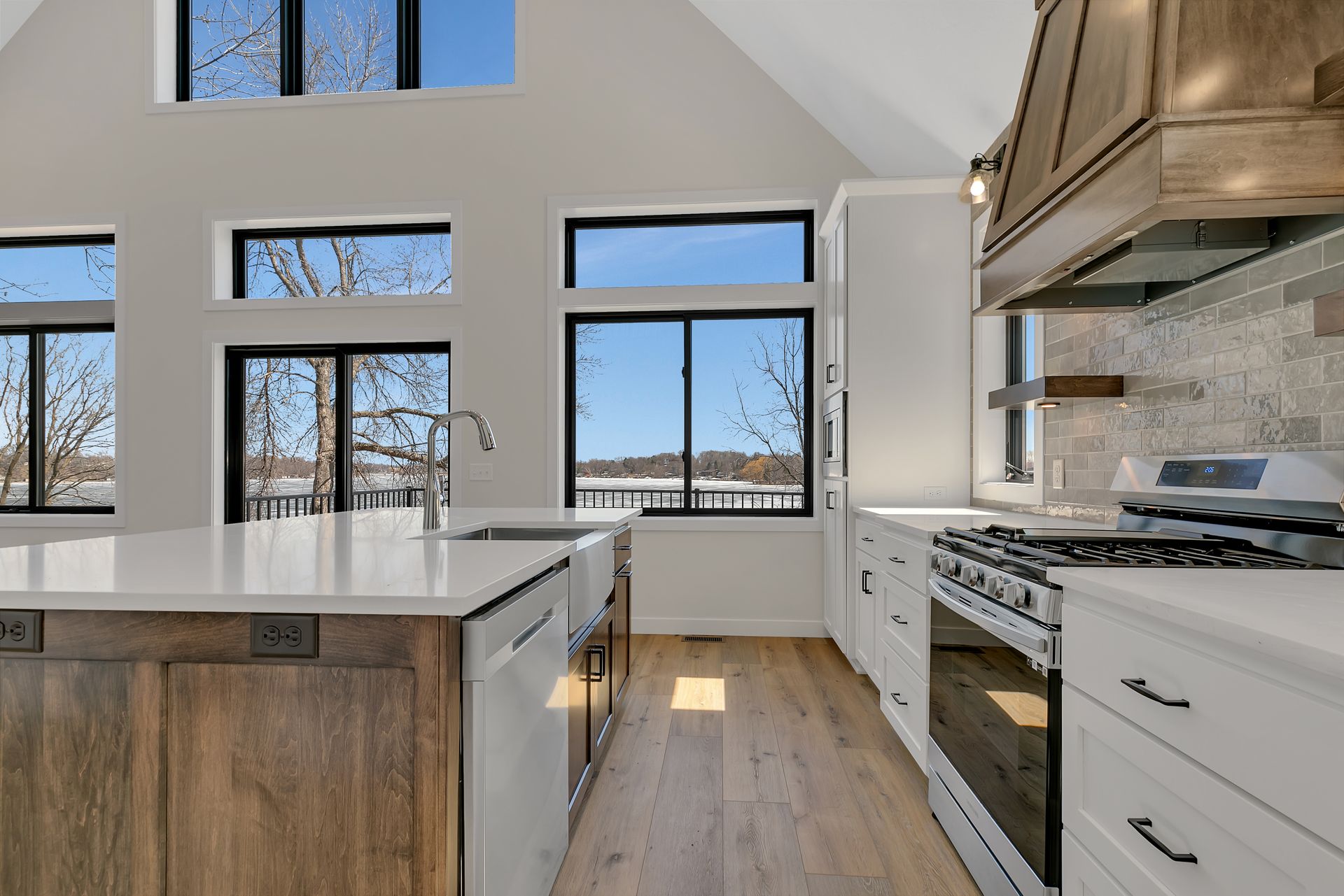 A kitchen with a lot of windows and a stove.